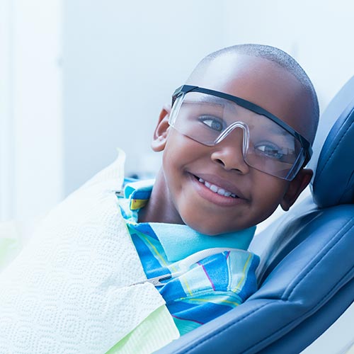 smiling boy waiting for dental exam in Brampton