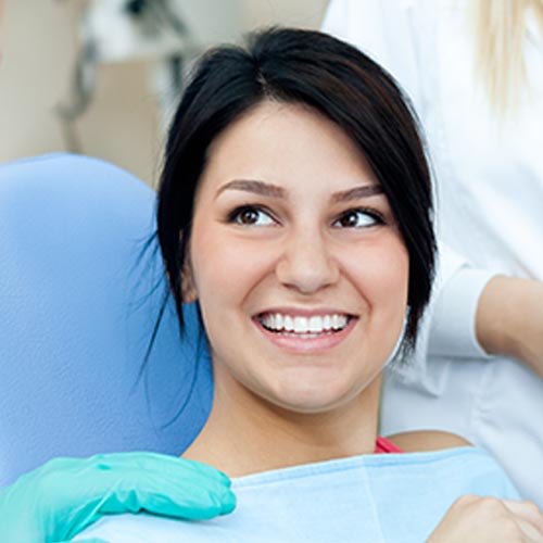 smiling woman at dental hygiene appointment in Brampton