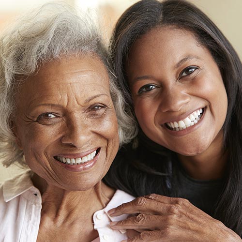 mother daughter hugging smiling after treatment at tridont dental in brampton